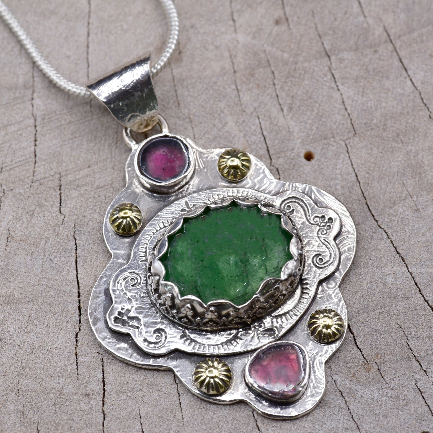 Boho style pendant necklace with a large green tourmaline in hand crafted sterling silver setting accented with watermelon tourmaline slices. (N513)