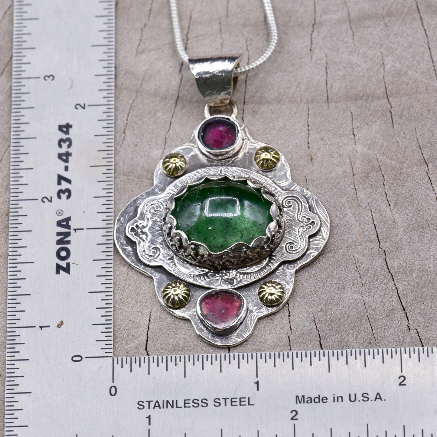 Boho style pendant necklace with a large green tourmaline in hand crafted sterling silver setting accented with watermelon tourmaline slices. (N513)