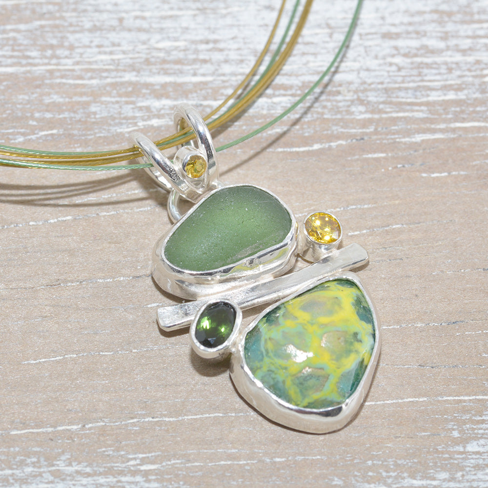 Sea glass and vitreous enamel pendant necklace in shades of yellow and green in a handcrafted setting of sterling silver accented with semi-precious gemstones. (N621)