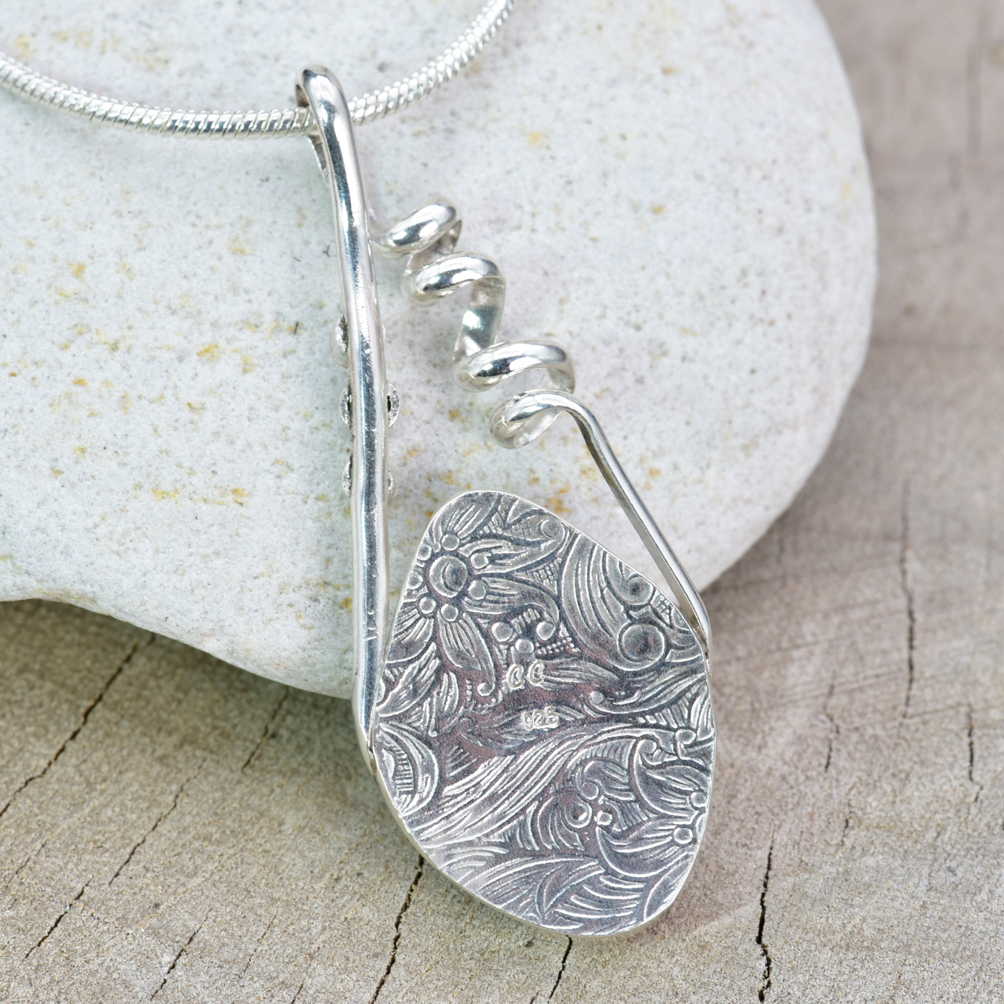 Fused dichroic glass pendant in a handmade setting of sterling silver accented with sparkly cubic zirconias. (N876)