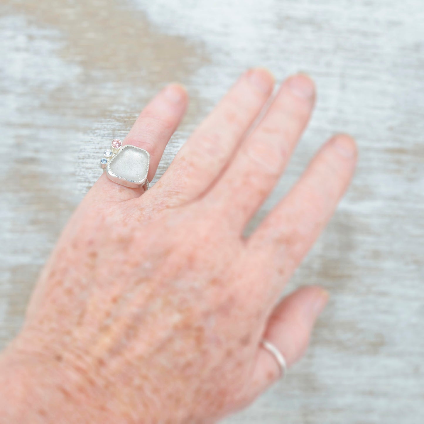 Sea glass ring with accented with sparkly cubic zirconias in sterling silver. (R531)