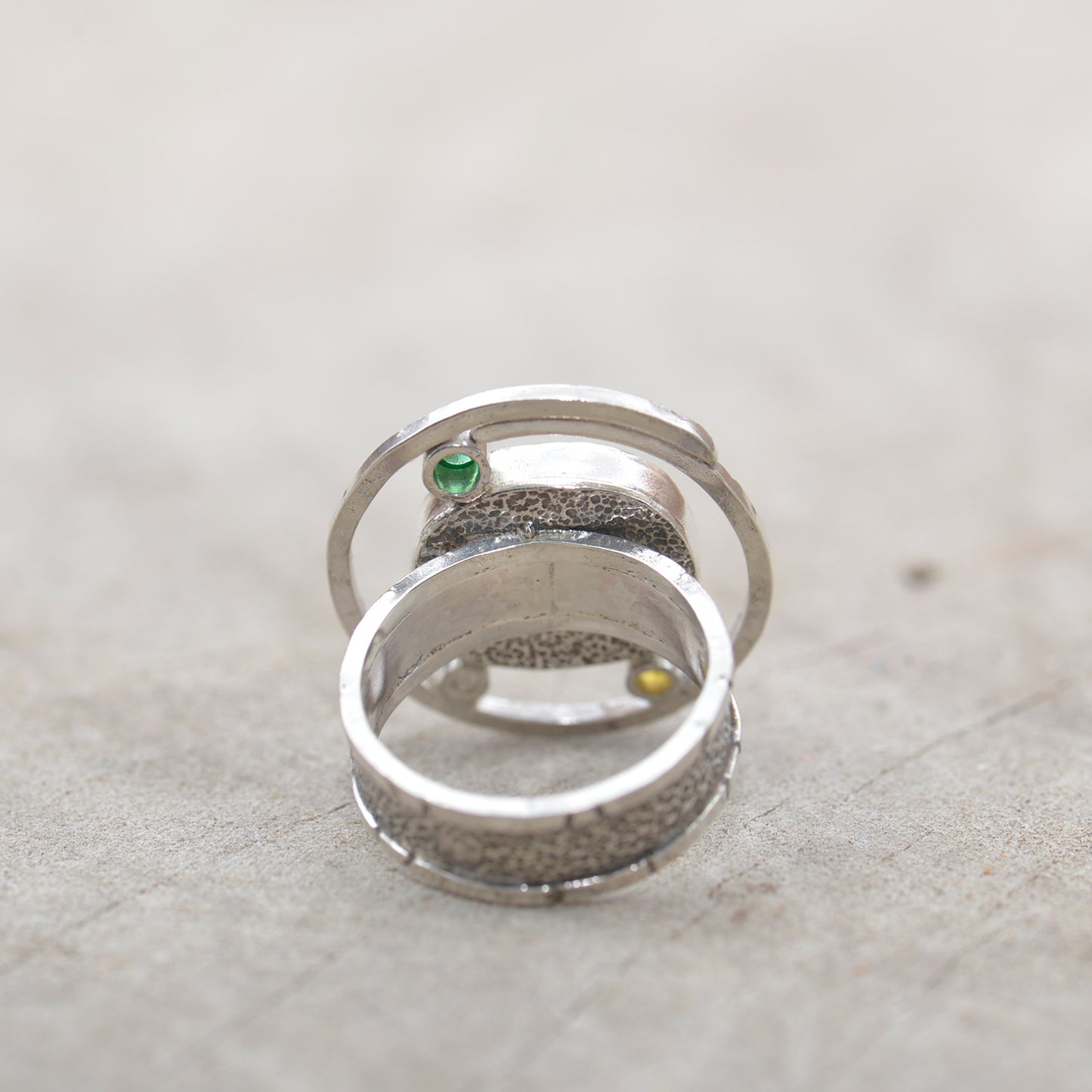 Dichroic glass ring in tones of green and yellow in a hand crafted setting of sterling silver. (R700)