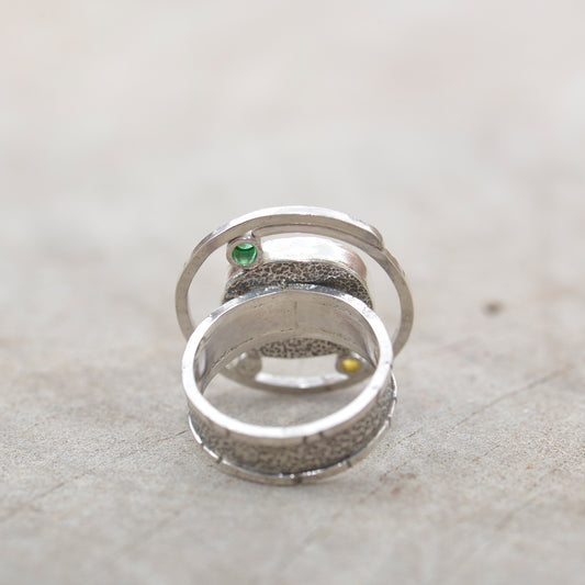Dichroic glass ring in tones of green and yellow in a hand crafted setting of sterling silver. (R700)