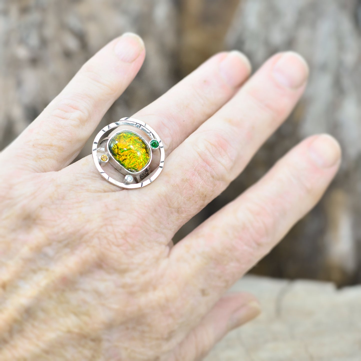 Dichroic glass ring in tones of green and yellow in a hand crafted setting of sterling silver. (R700)
