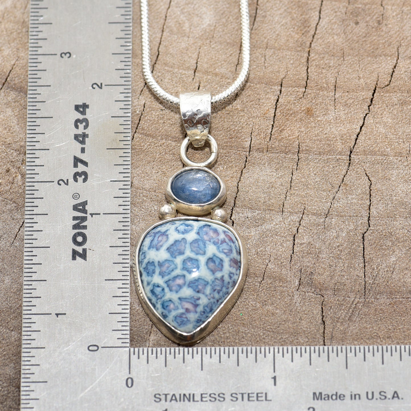 Pendant necklace with hand made enamel cabochon in shades of blue in a setting of sterling silver. (N764)