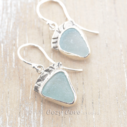 Light blue sea glass earrings in hand made settings of tarnish resistant sterling silver. (E336)
