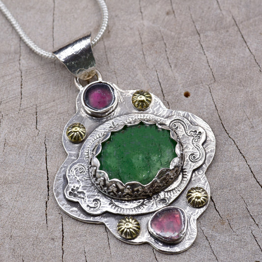 Boho style pendant necklace with a large green tourmaline in  hand crafted sterling silver setting accented with watermelon tourmaline slices. (N513)