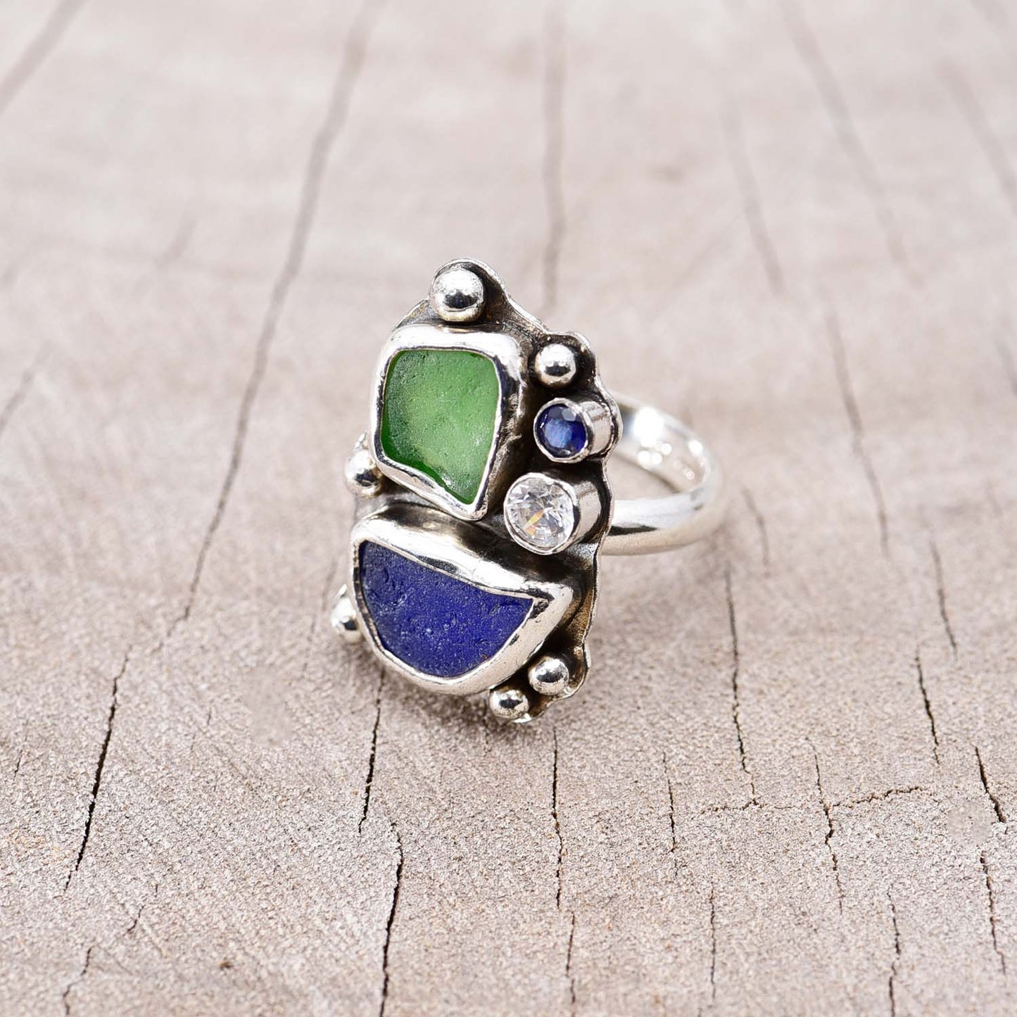 Sea glass ring with kelly green and cobalt blue pieces in a handcrafted sterling silver setting accented with a sparkly cubic zirconia (R745)