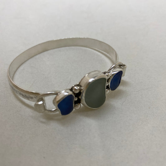 Sea glass cuff bracelet with seafoam green sea glass flanked by cornflower blue in a handcrafted setting of sterling silver. (B791)
