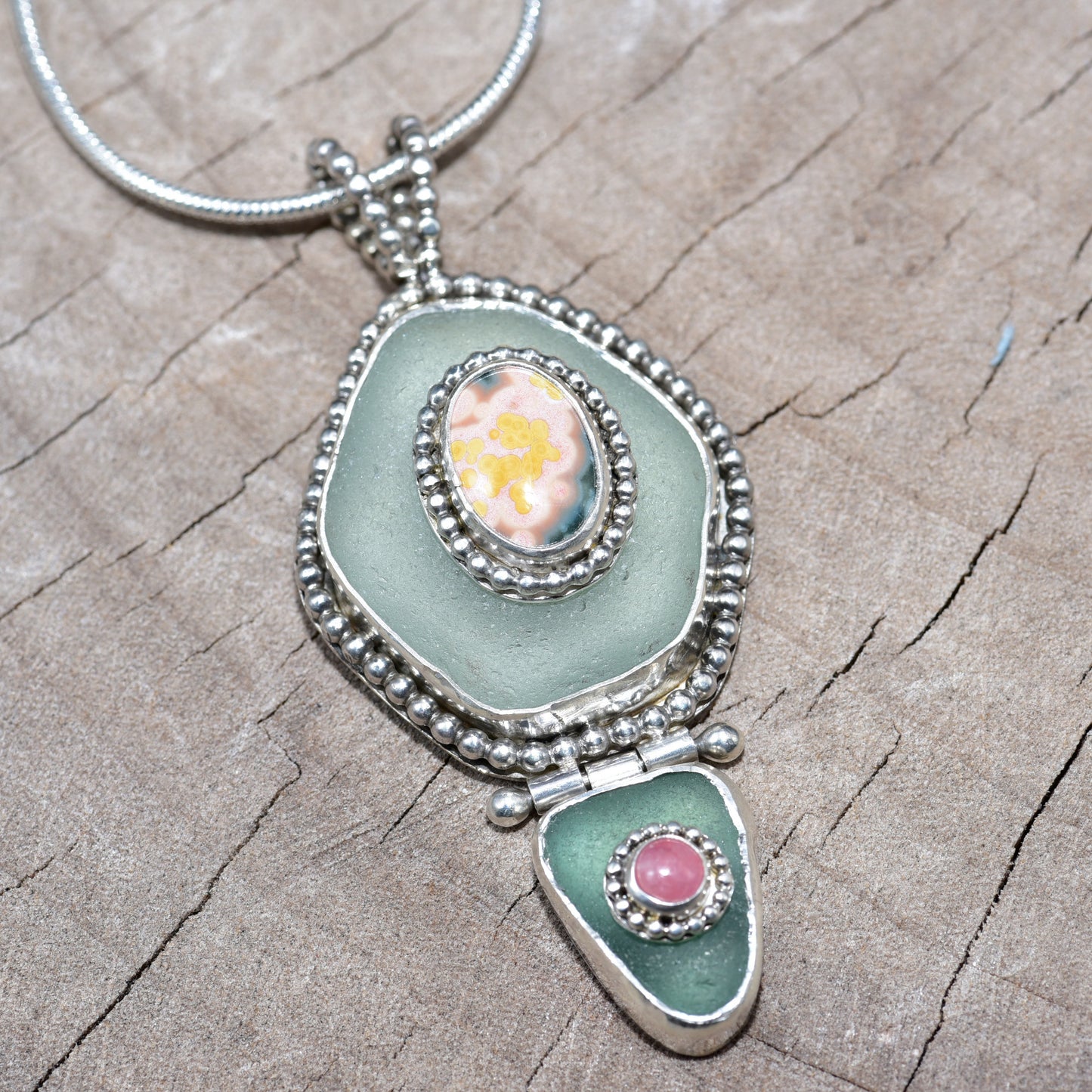 Sea glass and stone pendant necklace in a hand crafted setting of sterling silver. (N831)
