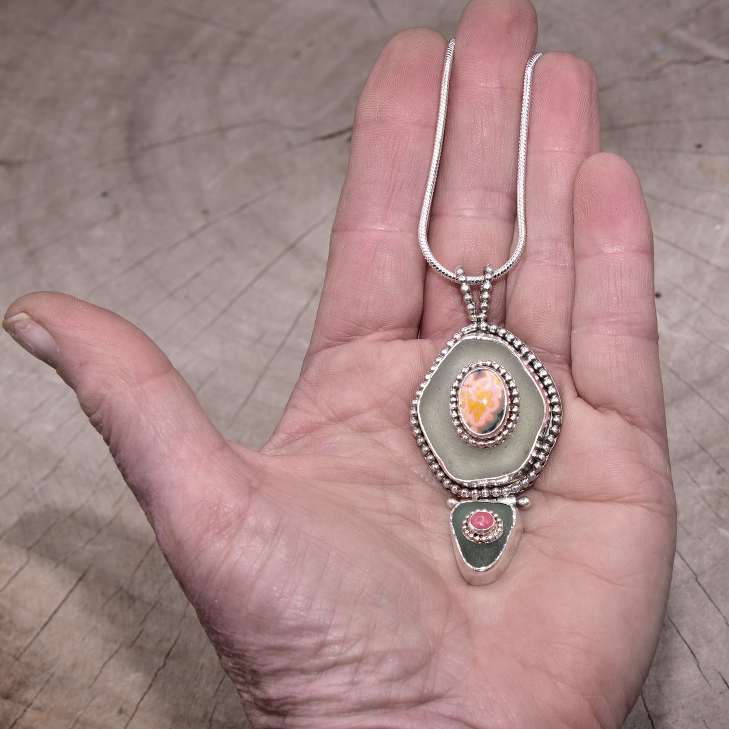 Sea glass and stone pendant necklace in a hand crafted setting of sterling silver. (N831)