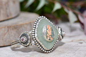 Sea glass and stone cuff bracelet in a hand crafted setting of sterling silver. (B832)