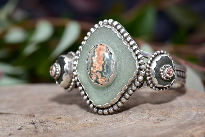 Sea glass and stone cuff bracelet in a hand crafted setting of sterling silver. (B832)
