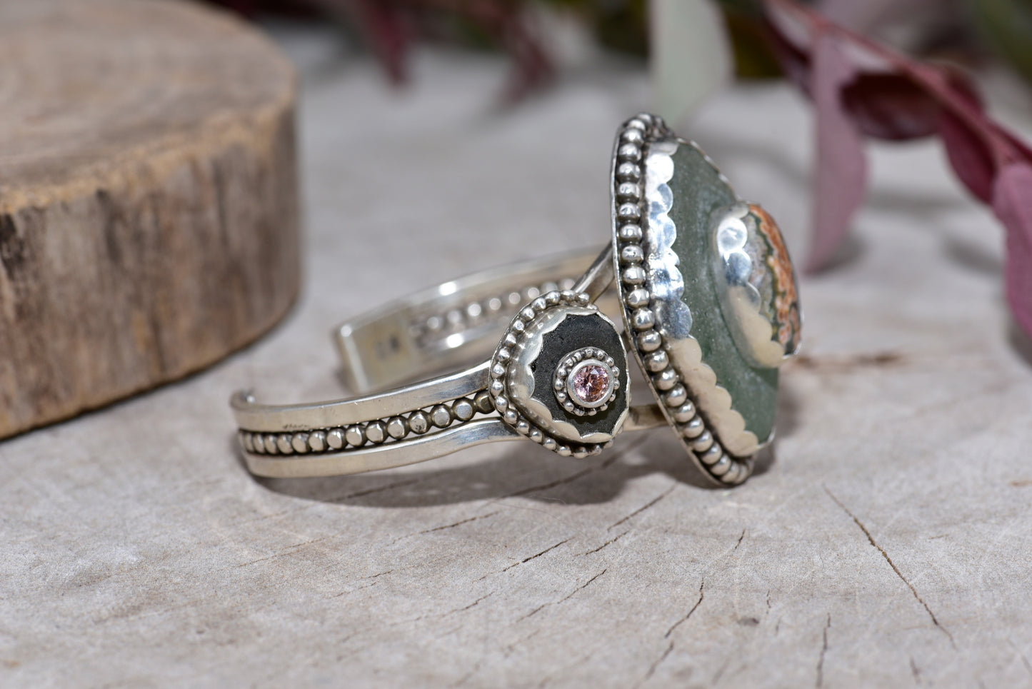 Sea glass and stone cuff bracelet in a hand crafted setting of sterling silver. (B832)