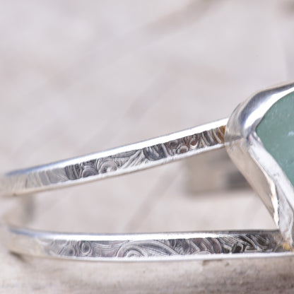 Close-up of the double cuff bands showing the hand pattern-rolled floral scrollwork in the sterling silver