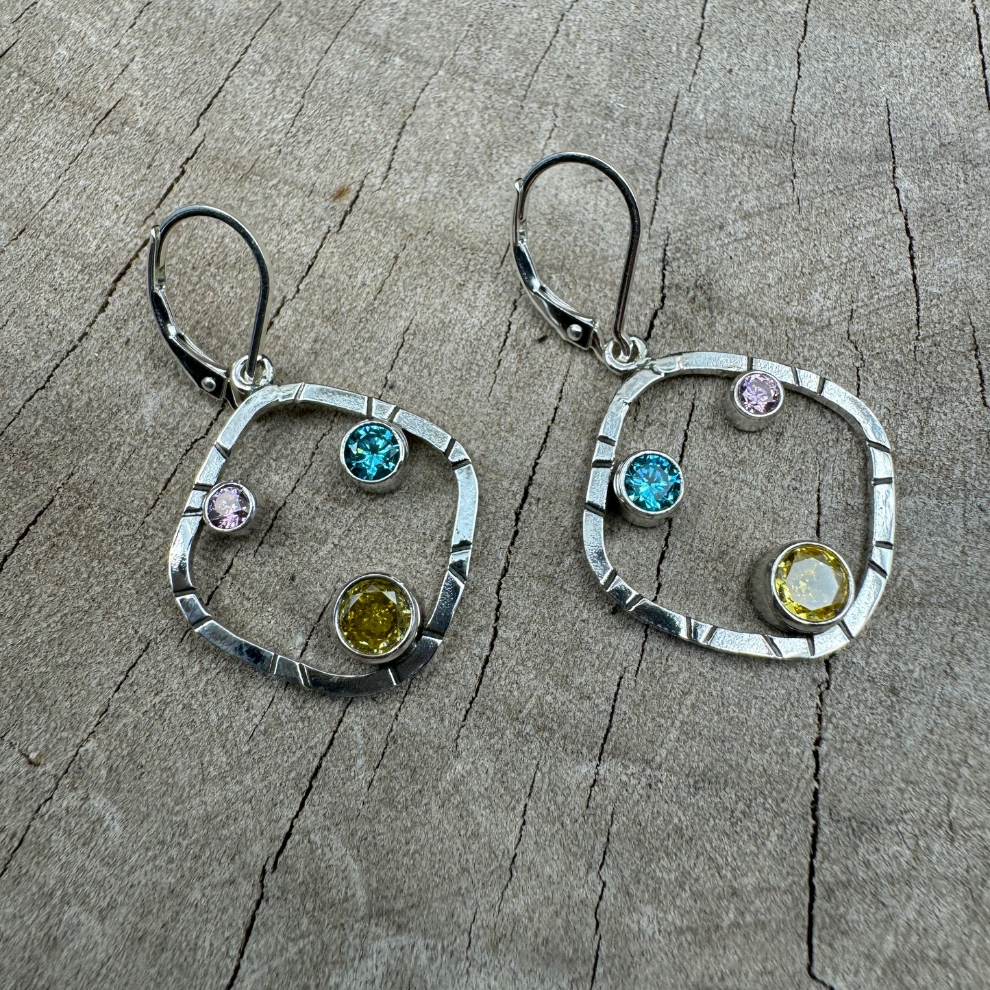 Sparkly multicolor cubic zirconia earrings in handcrafted settings of sterling silver. (E869)