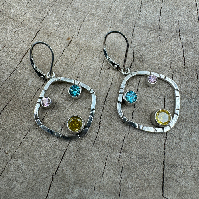 Sparkly multicolor cubic zirconia earrings in handcrafted settings of sterling silver. (E869)