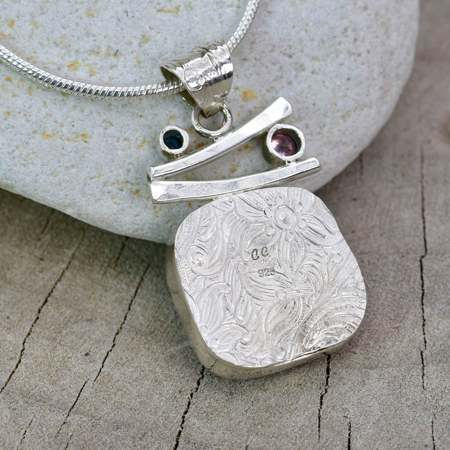 Fused dichroic glass pendant in a handmade setting of sterling silver accented with sparkly cubic zirconias. (N874)