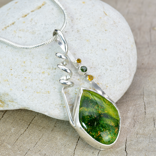 Fused dichroic glass pendant in a handmade setting of sterling silver accented with sparkly cubic zirconias. (N876)