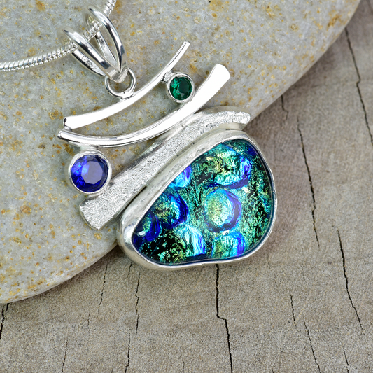 Fused dichroic glass pendant in a hand crafted setting of sterling silver. (N898)