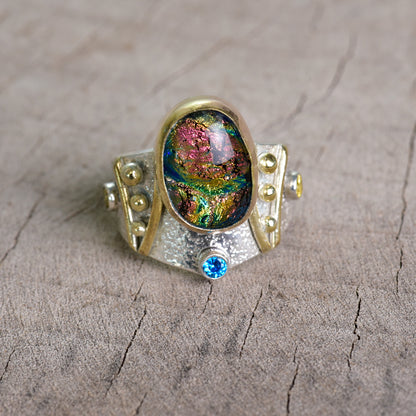 Fused dichroic glass ring in a hand crafted setting of sterling silver with gold accents. (R925)