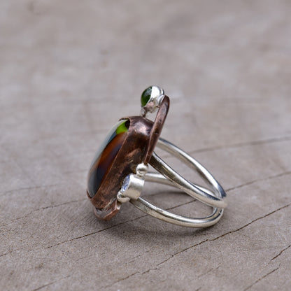 Silver ring in copper and silver on a wooden surface