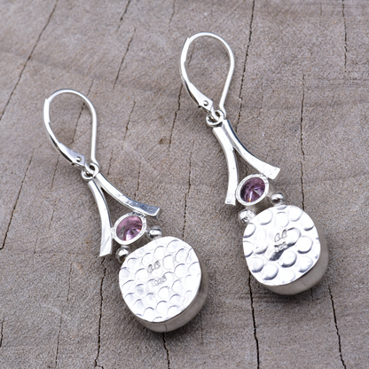 Backs of the sterling silver earrings showing the pebbled embossed texture and the CC maker's mark