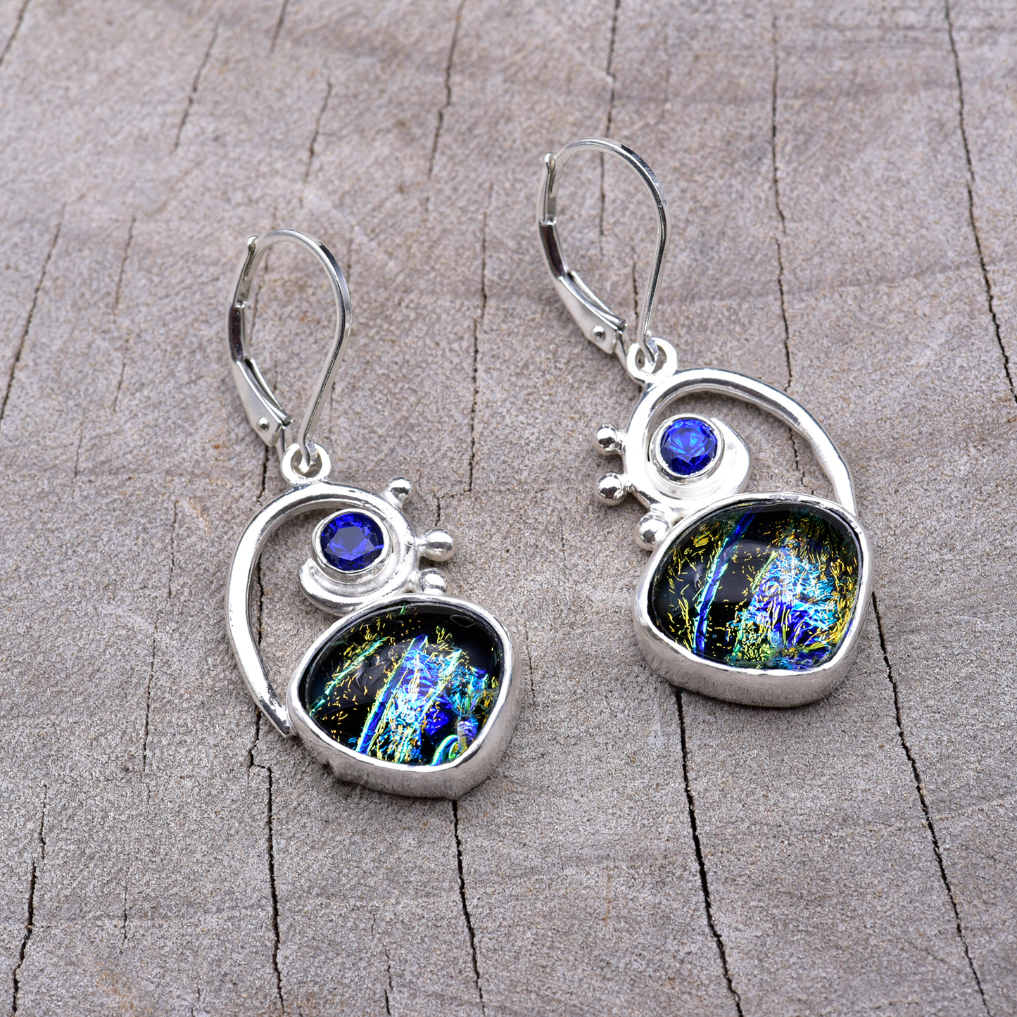 Blue, teal and gold dichroic glass dangle earrings in spiral sterling silver settings with sapphire blue cubic zirconia