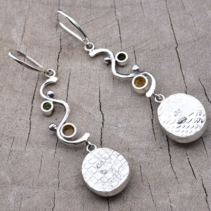 Backs of the earrings showing the pattern-rolled embossed silver bezels with the CC maker's mark and 925 sterling hallmark
