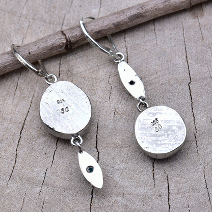 Backs of the earrings showing the pattern-rolled silver bezels stamped with the CC maker's mark and 925 sterling hallmark