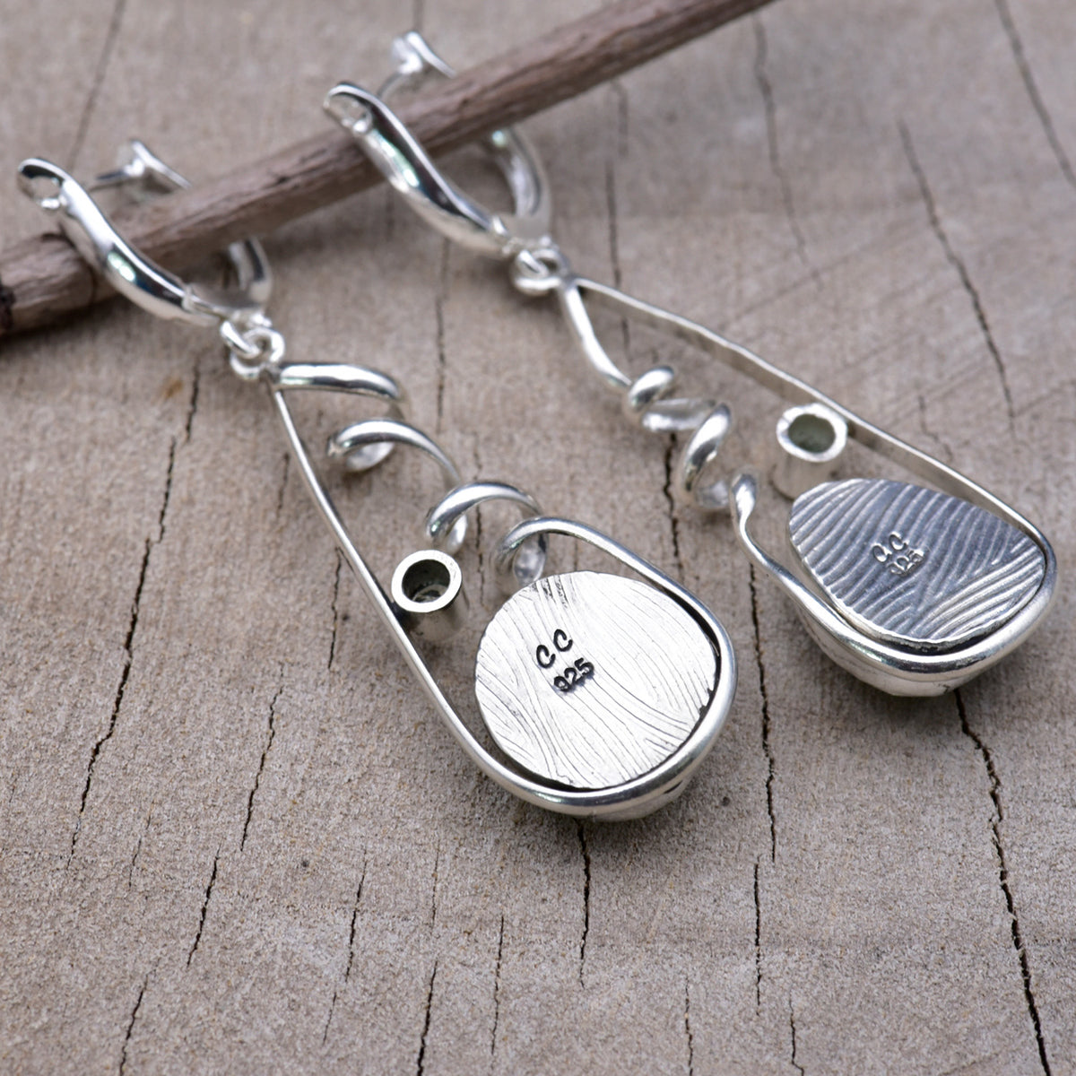 Back of the sterling silver earrings showing the textured embossed bezel backs stamped with the CC maker's mark and 925 hallmark