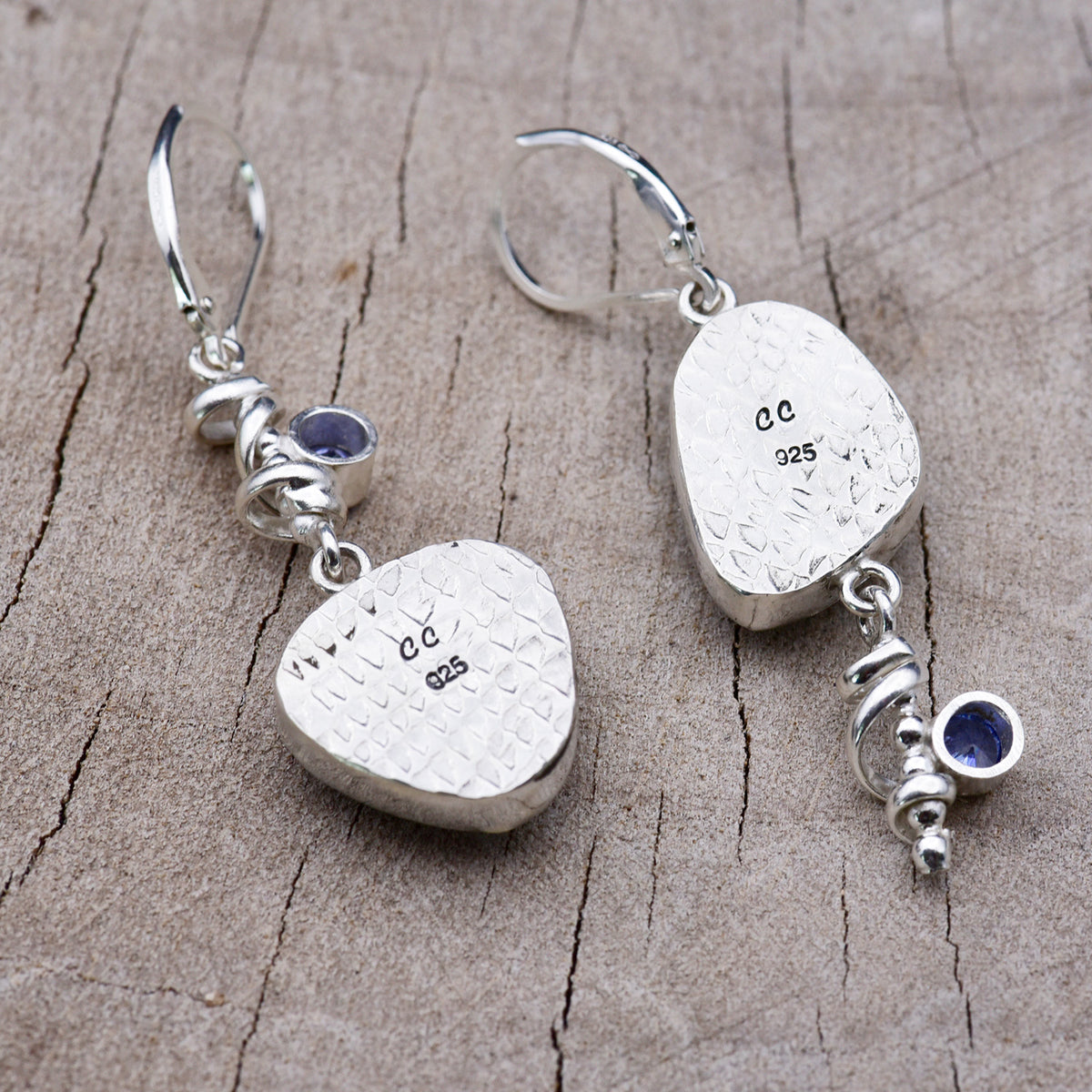 Back of the sterling silver earrings showing the diamond-patterned embossed bezel backs stamped with the CC maker's mark and 925 hallmark