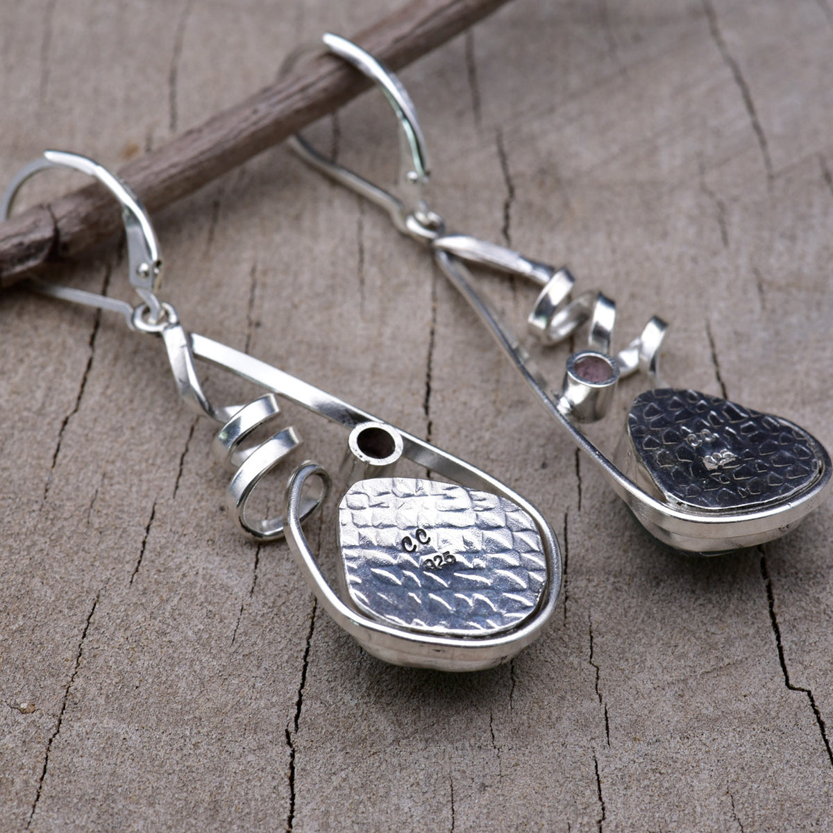 Back of the sterling silver earrings showing the textured embossed bezel backs stamped with the CC maker's mark and 925 hallmark