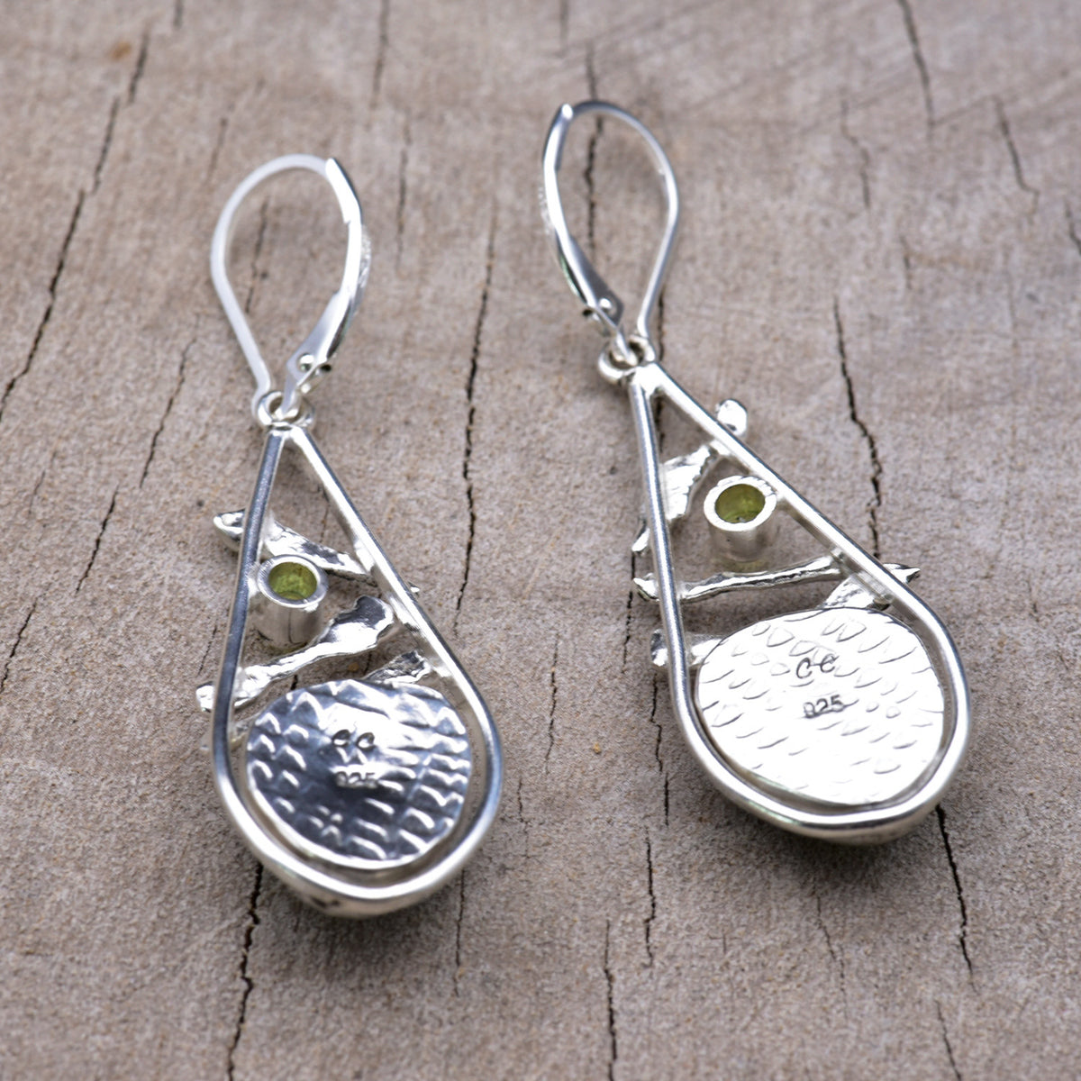 Back of the sterling silver earrings showing the textured embossed bezel backs stamped with the CC maker's mark and 925 hallmark