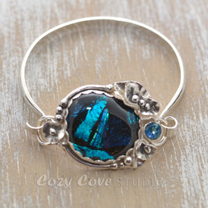 Statement cuff bracelet with a dichroic glass in shades of blue in a setting of sterling silver. (B378)