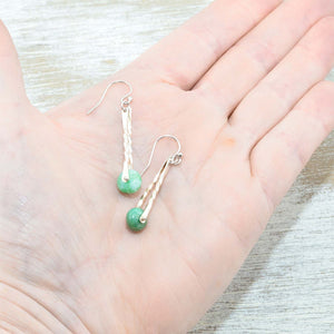 Hand made trapeze earrings capture semi-precious chrysoprase gemstone beads between twists of sterling silver. (E451)