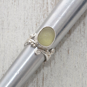 Green sea glass ring in sterling silver on ring stick