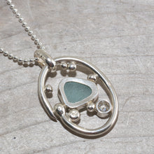 Load image into Gallery viewer, Sea glass necklace in a hand crafted tarnish resistant sterling silver setting accented with pebbles and a sparkly CZ. (N492)
