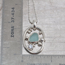 Load image into Gallery viewer, Sea glass necklace in a hand crafted tarnish resistant sterling silver setting accented with pebbles and a sparkly CZ. (N492)
