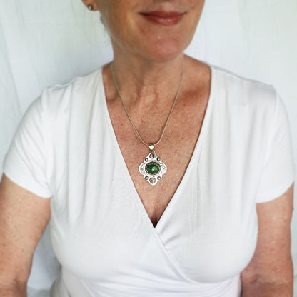 Boho style pendant necklace with a large green tourmaline in  hand crafted sterling silver setting accented with watermelon tourmaline slices. (N513)