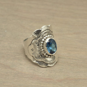 Boho style ring with a sparkly blue topaz cubic zirconia in a hand crafted setting of sterling silver. (R516)