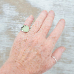 Sea glass ring with pale green sea glass accented with  a sparkly peridot in sterling silver. (R528)