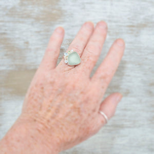 Sea glass ring with pale green sea glass accented with sparkly cubic zirconias  in sterling silver. (R532)