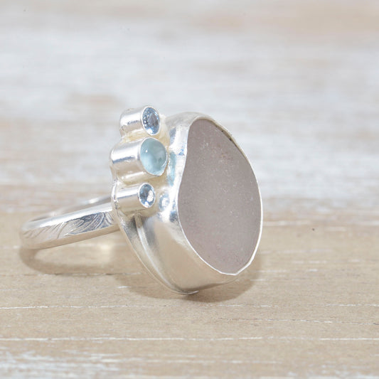 Sea glass ring accented with an aquamarine and sparkly cubic zirconias in sterling silver. (R533)