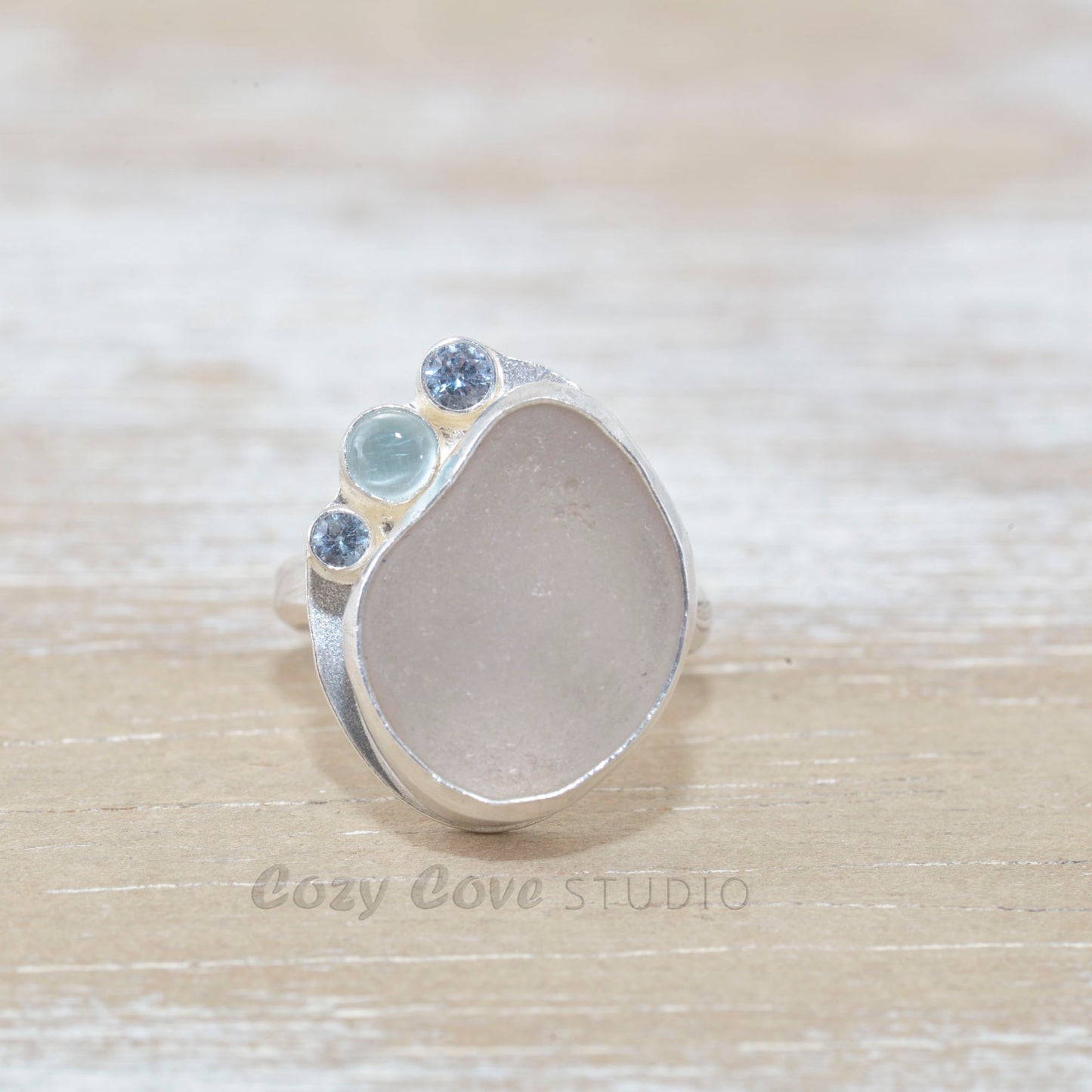 Sea glass ring  accented with an aquamarine and sparkly cubic zirconias  in sterling silver. (R533)