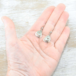 Sea glass earrings in pale green accented with sterling silver studs. (E577)