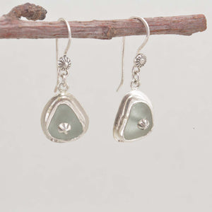 Sea glass earrings in pale green accented with sterling silver studs. (E577)