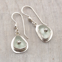Load image into Gallery viewer, Sea glass earrings in pale blue accented with sterling silver studs.
