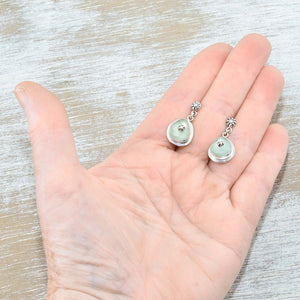 Sea glass earrings in pale green accented with sterling silver studs. (E578)