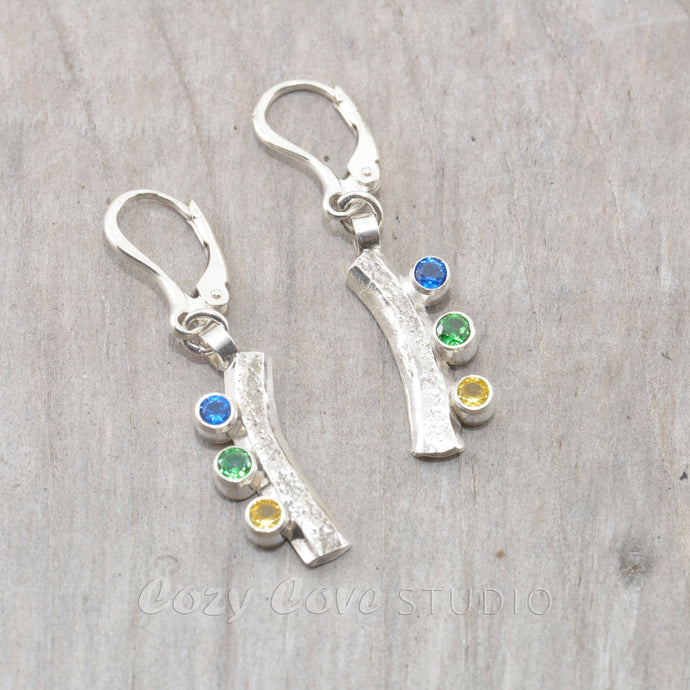Sparkly dangle earrings with colorful cubic zironias in hand crafted settings of sterling silver.